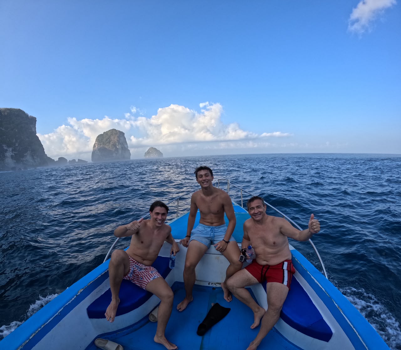 Happy guests on the bow of a snorkeling boat
